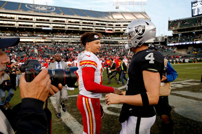 Dec 2, 2018; Oakland, CA, USA; Kansas City Chiefs quarterback Patrick Mahomes (15) meets with Oakland Raiders quarterback Derek Carr (4) after the game at Oakland Coliseum. Mandatory Credit: Cary Edmondson-USA TODAY Sports